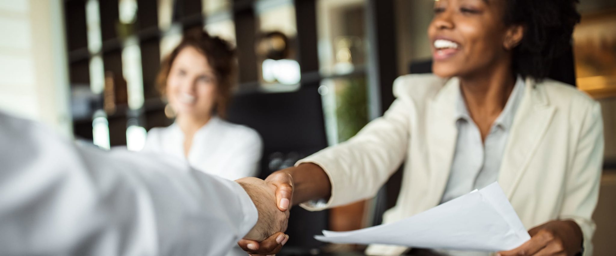 Common Types of Surety Bonds & How They Work Happy Woman Shaking Hands With Man