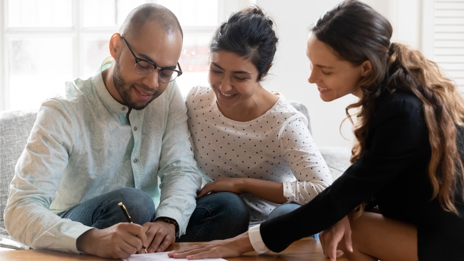 Jan 22 Blog female insurance agent discussing life insurance options with young couple